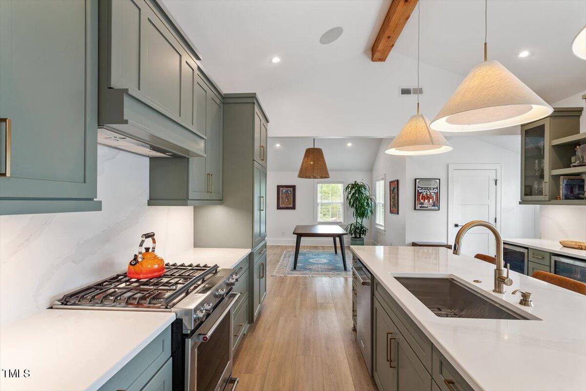 1112 Watauga Street Raleigh, NC 27604 - Photo 10 of 32 a kitchen with stainless steel appliances granite countertop a sink and a wooden floors