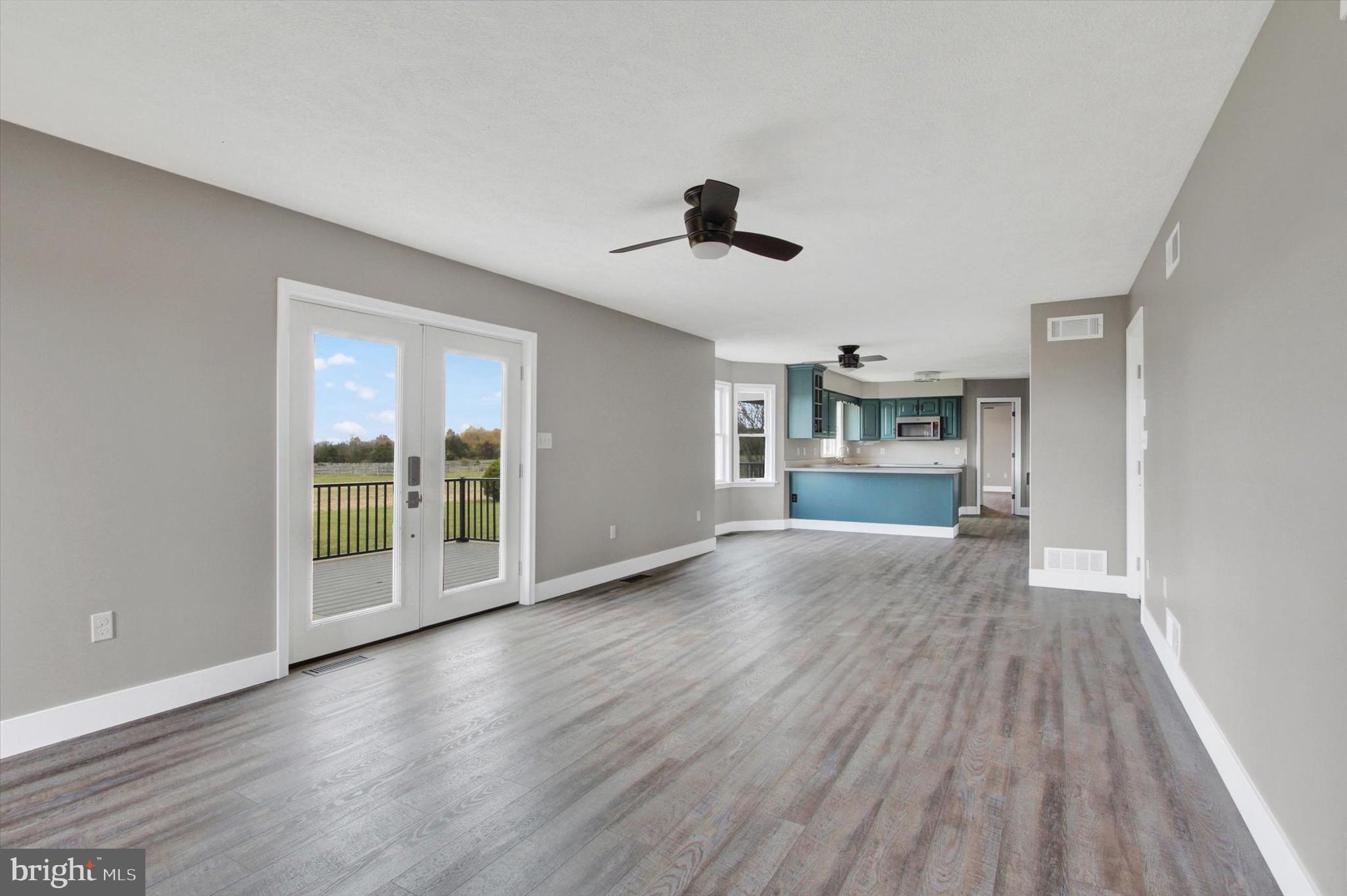 30 Harney Road Littlestown, PA 17340 - Photo 12 of 45 wooden floor in an empty room with a kitchen