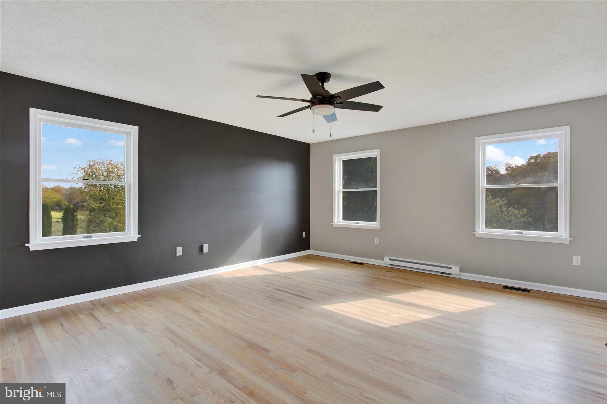 30 Harney Road Littlestown, PA 17340 - Photo 23 of 45 a view of an empty room with a window and wooden floor