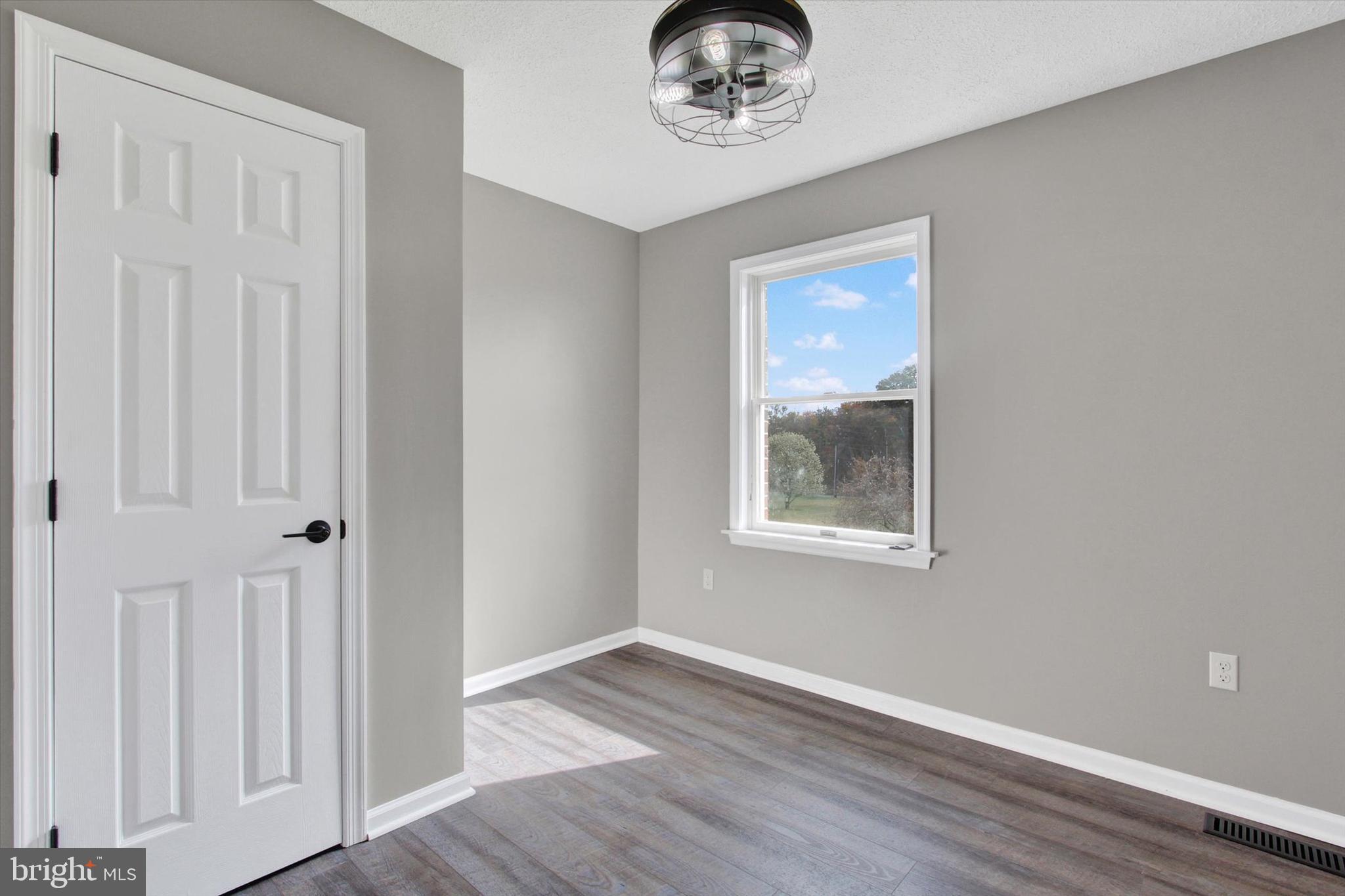 30 Harney Road Littlestown, PA 17340 - Photo 30 of 45 a view of an empty room with a window and wooden floor