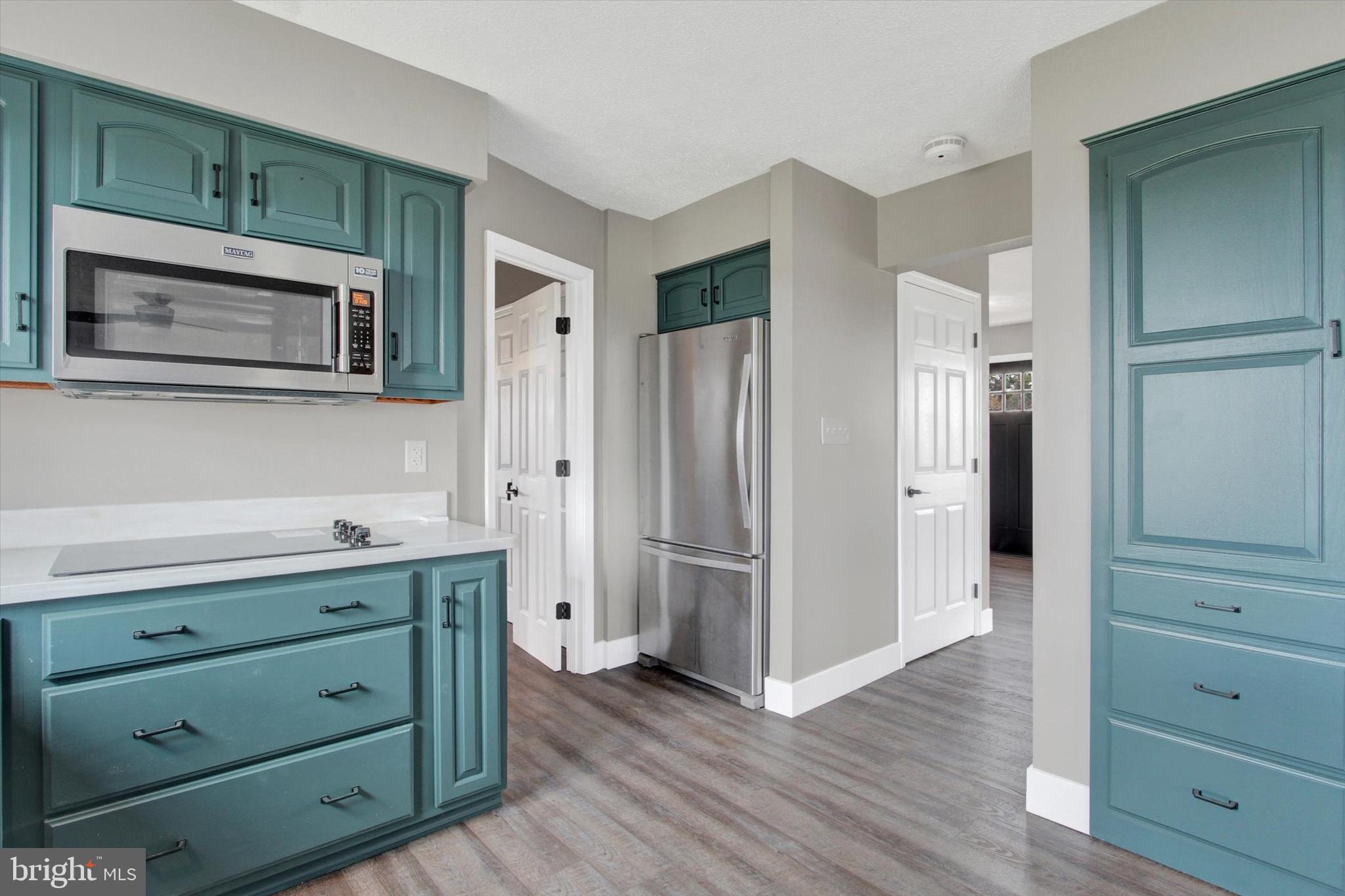 30 Harney Road Littlestown, PA 17340 - Photo 8 of 45 a kitchen with stainless steel appliances granite countertop a refrigerator and a microwave oven