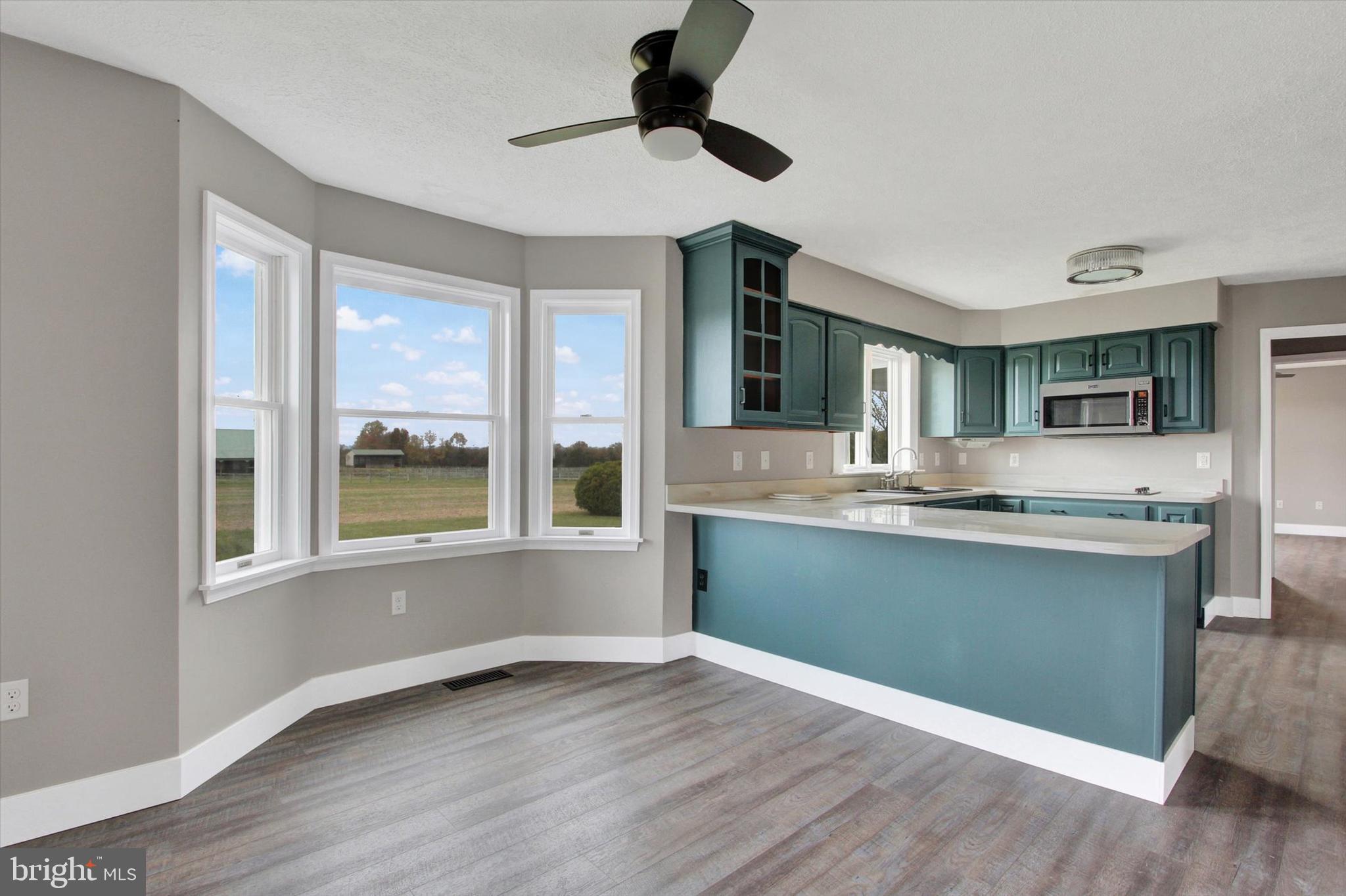 30 Harney Road Littlestown, PA 17340 - Photo 10 of 45 a kitchen with granite countertop a sink cabinets and wooden floor