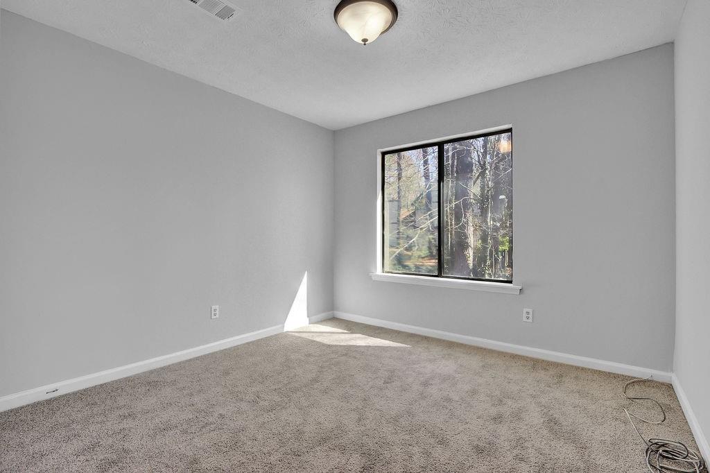 5409 Biffle Downs Road Stone Mountain, GA 30088 - Photo 17 of 27 wooden floor in an empty room with a window