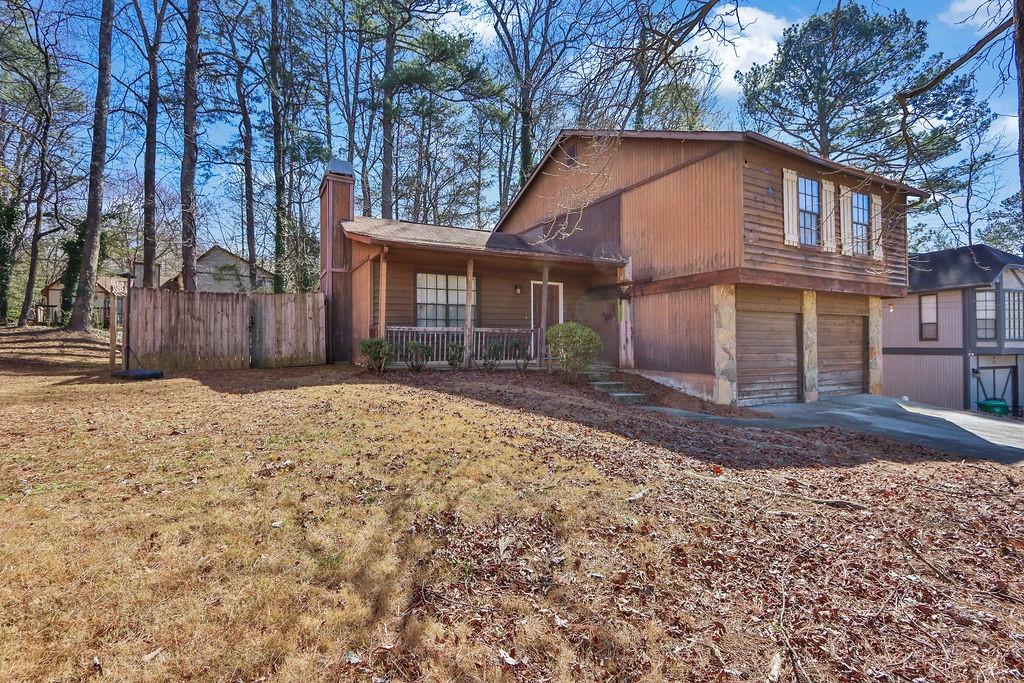 5409 Biffle Downs Road Stone Mountain, GA 30088 - Photo 3 of 27 a front view of a house with a yard and garage