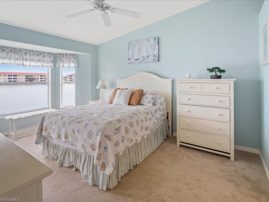 2810 Cypress Trace Circle, Unit 2127 Naples, FL 34119 - Photo 15 of 28 a bedroom with a bed and a cabinets