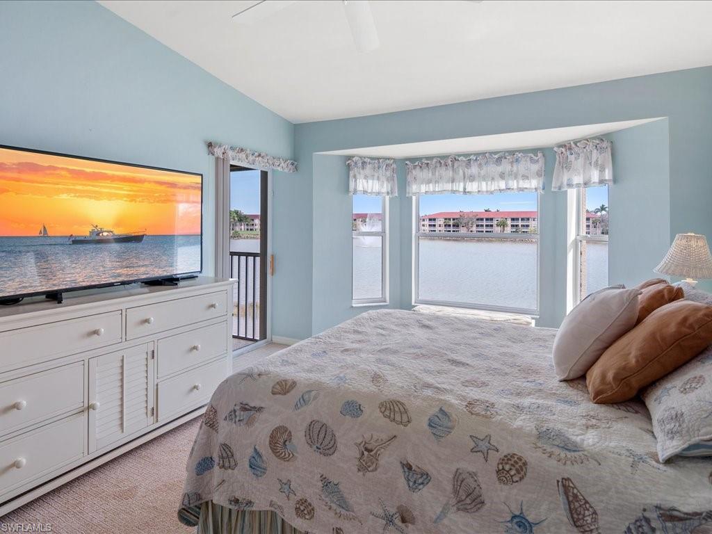 2810 Cypress Trace Circle, Unit 2127 Naples, FL 34119 - Photo 17 of 28 a bedroom with a bed and a flat screen tv
