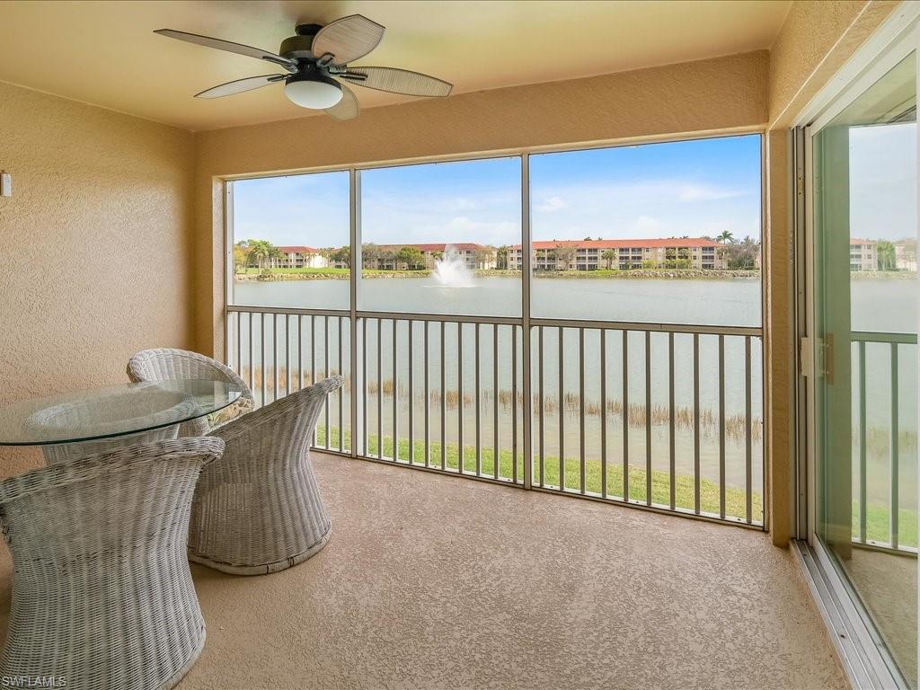 2810 Cypress Trace Circle, Unit 2127 Naples, FL 34119 - Photo 2 of 28 a view of a balcony with furniture and a window