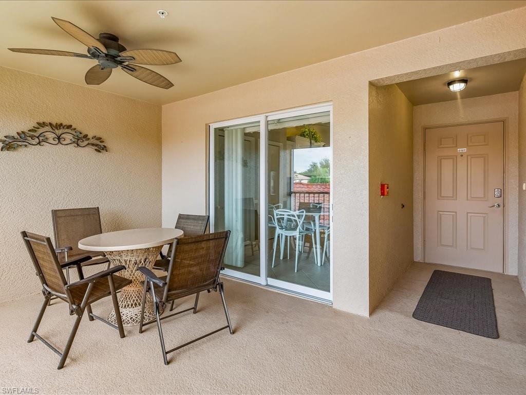 2810 Cypress Trace Circle, Unit 2127 Naples, FL 34119 - Photo 5 of 28 a view of a livingroom with furniture and a ceiling fan