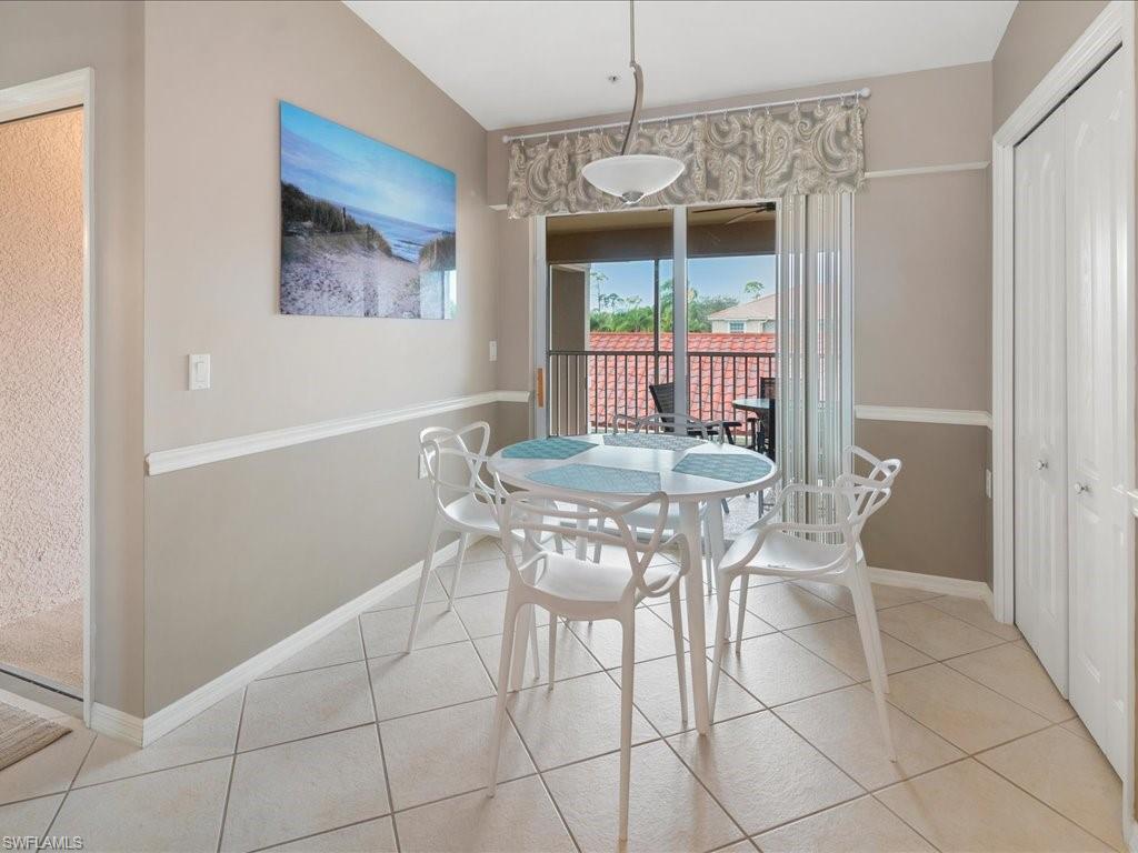 2810 Cypress Trace Circle, Unit 2127 Naples, FL 34119 - Photo 8 of 28 a dining room with furniture and window