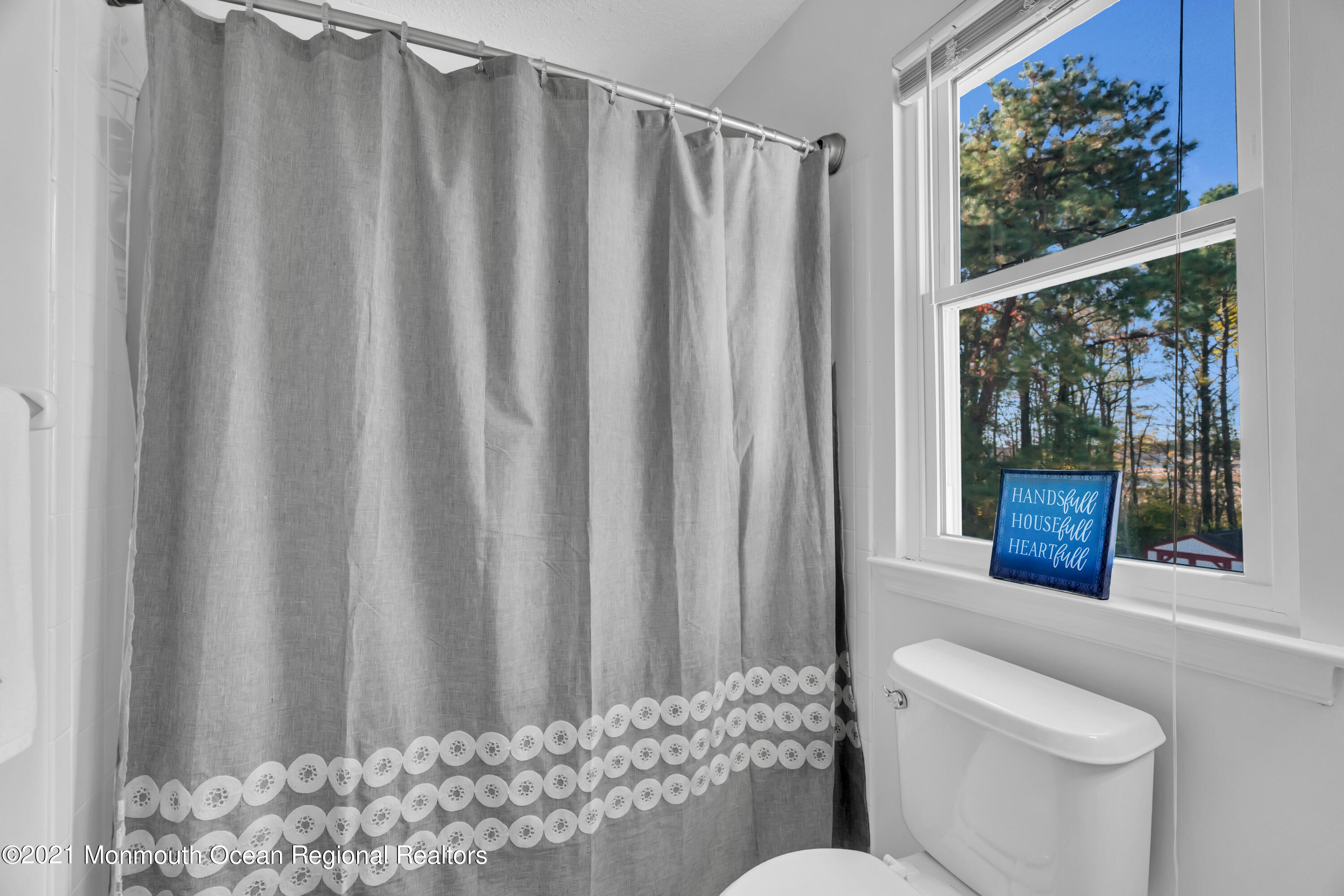 212 Cherry Quay Road Brick, NJ 08723 - Photo 22 of 44 a bathroom with a toilet and a shower curtain