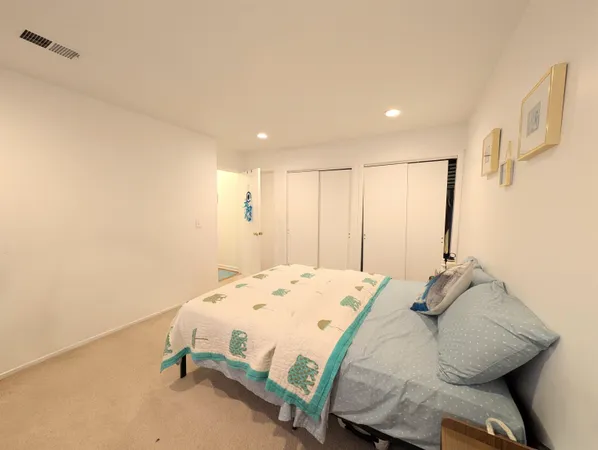 a bedroom with a bed and a dresser