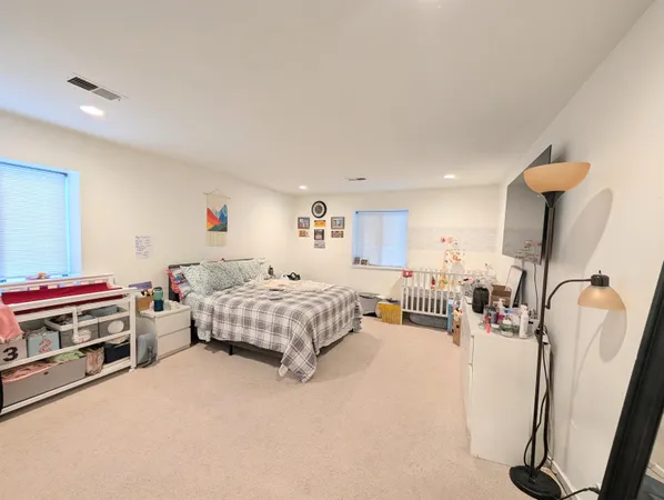 a bedroom with furniture and a flat screen tv