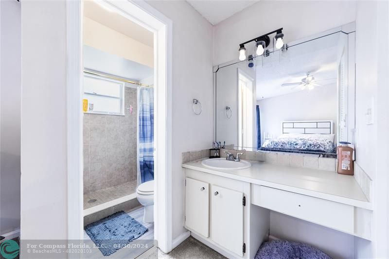 a bathroom with a double vanity sink toilet and shower