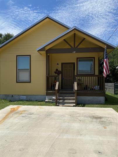 View of front of home with a porch and crawl space