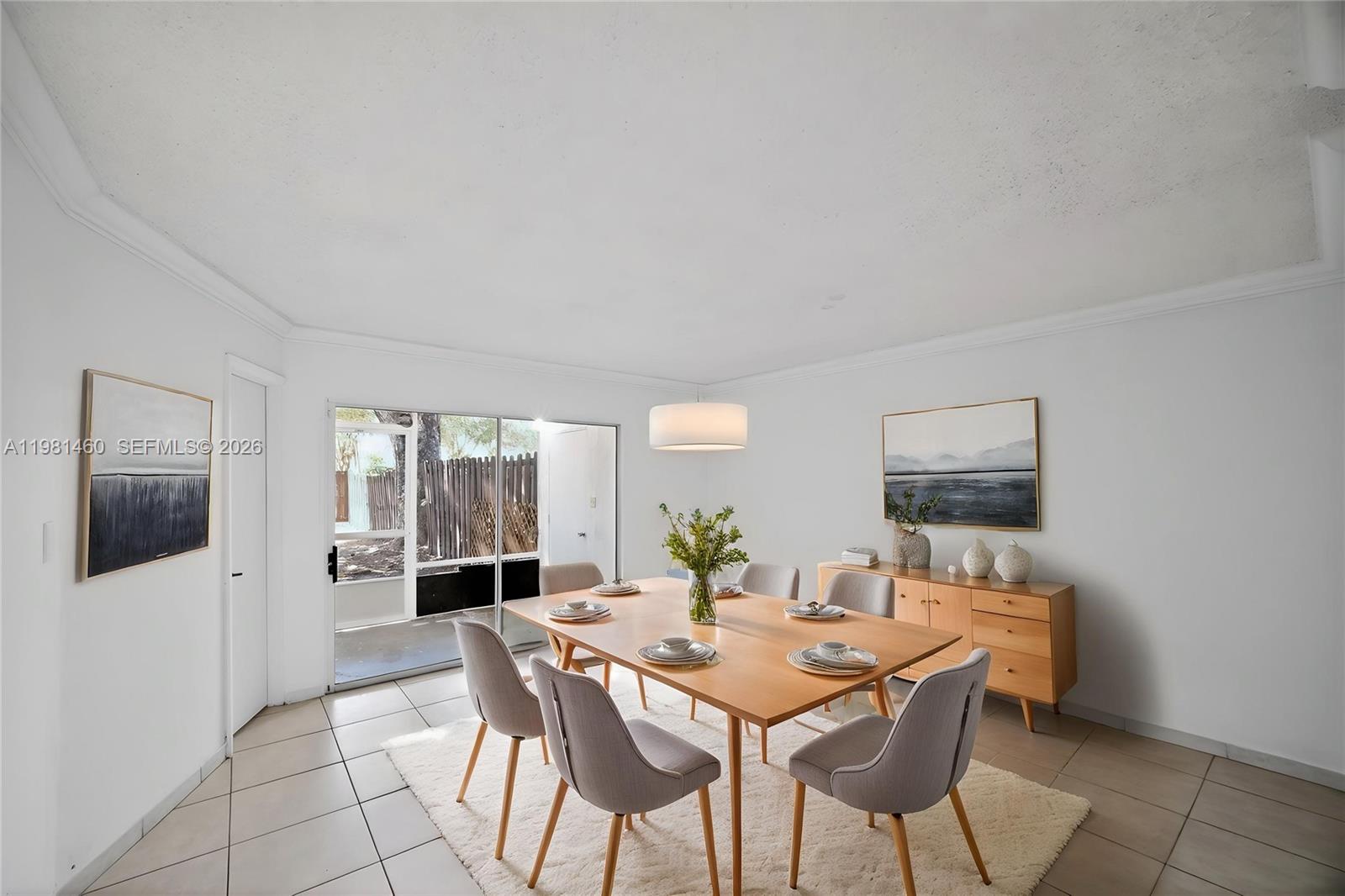 9436 Southwest 140th Court, Unit 9436 Miami, FL 33186 - Photo 17 of 40 a view of a dining room with furniture and wooden floor