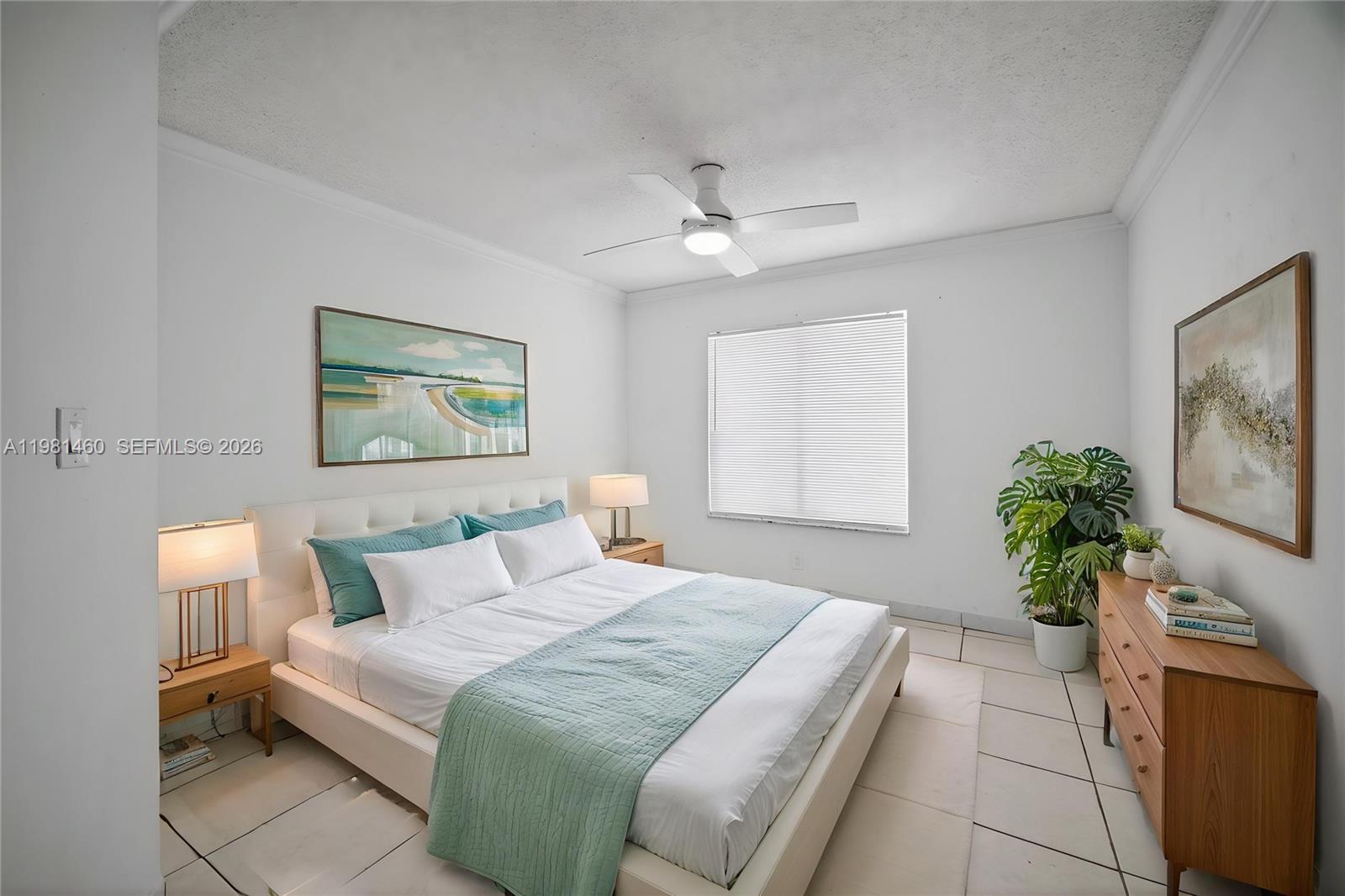 9436 Southwest 140th Court, Unit 9436 Miami, FL 33186 - Photo 19 of 40 a bedroom with a large bed and a potted plant