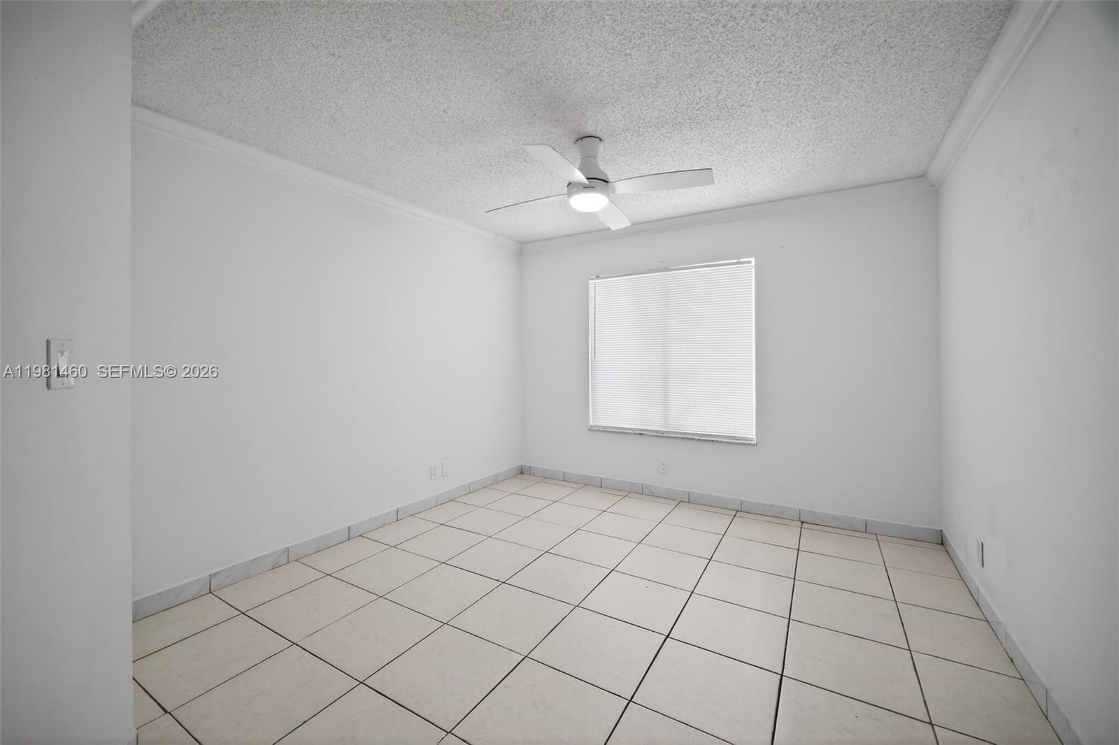 9436 Southwest 140th Court, Unit 9436 Miami, FL 33186 - Photo 20 of 40 an empty room with windows and fan