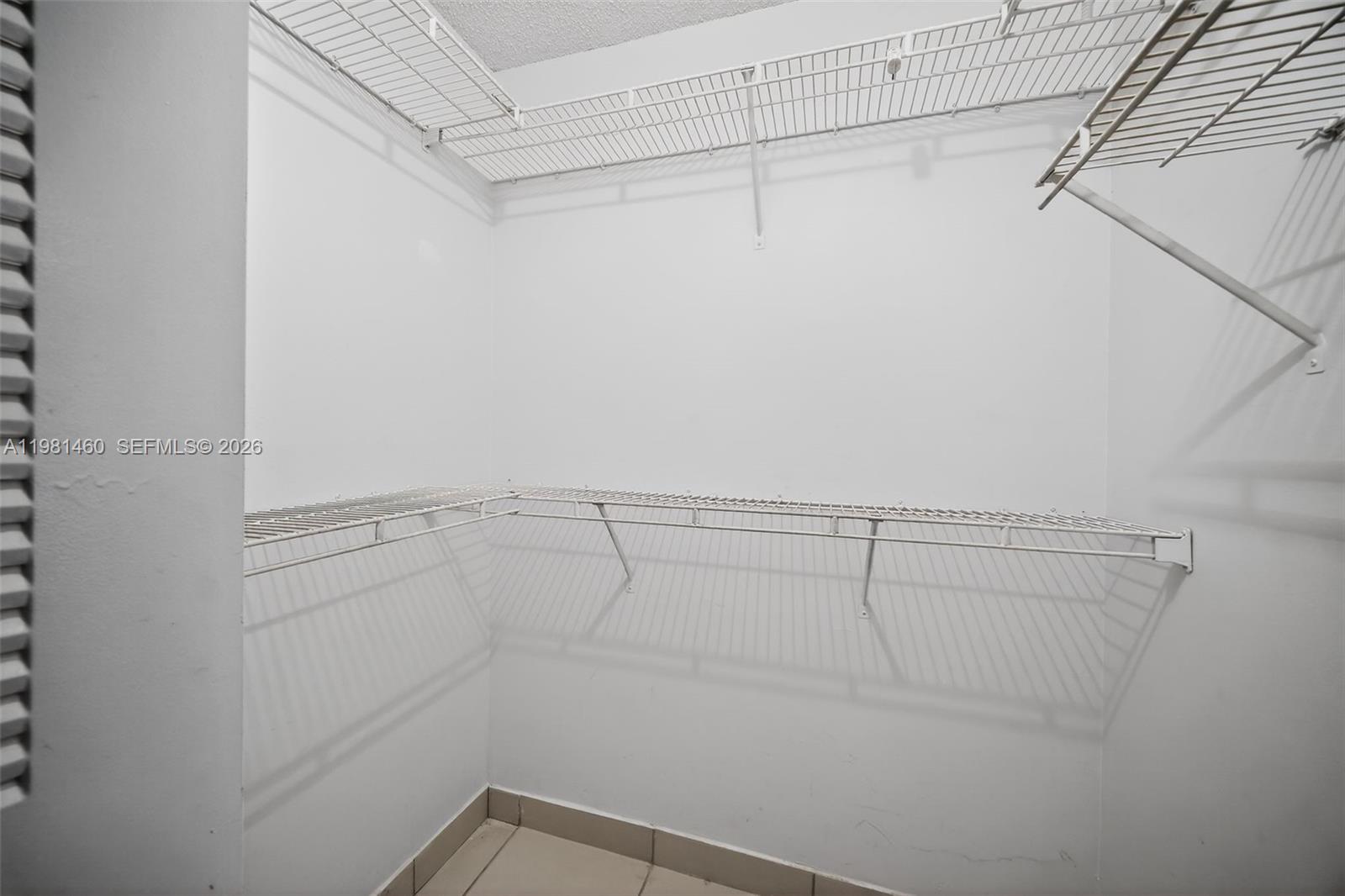 9436 Southwest 140th Court, Unit 9436 Miami, FL 33186 - Photo 23 of 40 a view of a room with racks on the wall