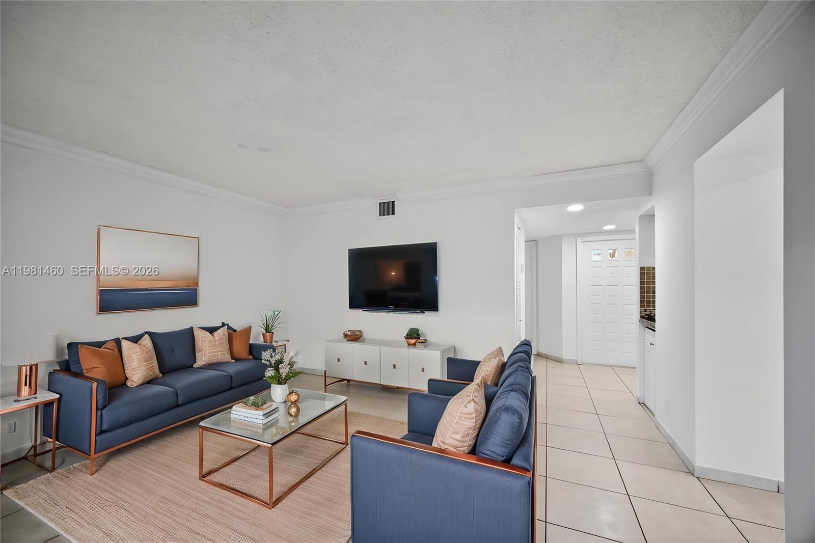 9436 Southwest 140th Court, Unit 9436 Miami, FL 33186 - Photo 4 of 40 a living room with furniture and a flat screen tv