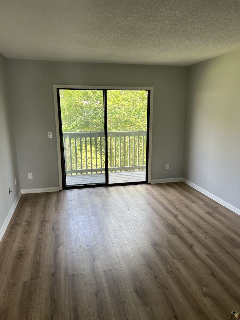 650 West Pope Road, Unit 263 St. Augustine, FL 32080 - Photo 2 of 4 a view of an empty room with wooden floor and a window