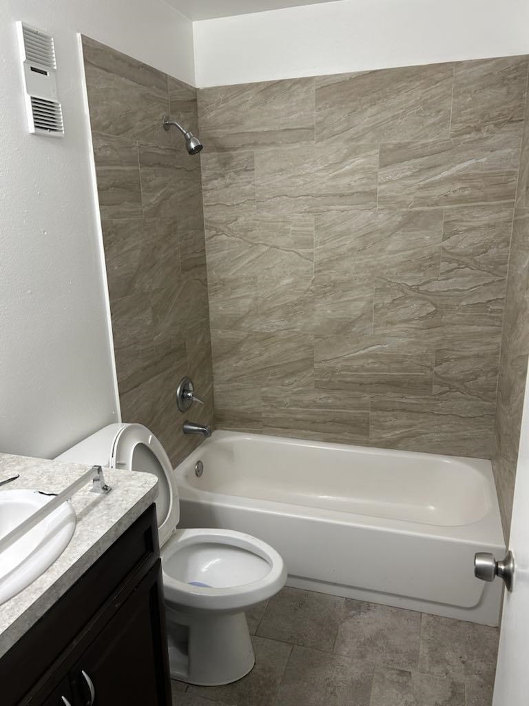 650 West Pope Road, Unit 263 St. Augustine, FL 32080 - Photo 4 of 4 a bathroom with a granite countertop toilet a sink and bathtub