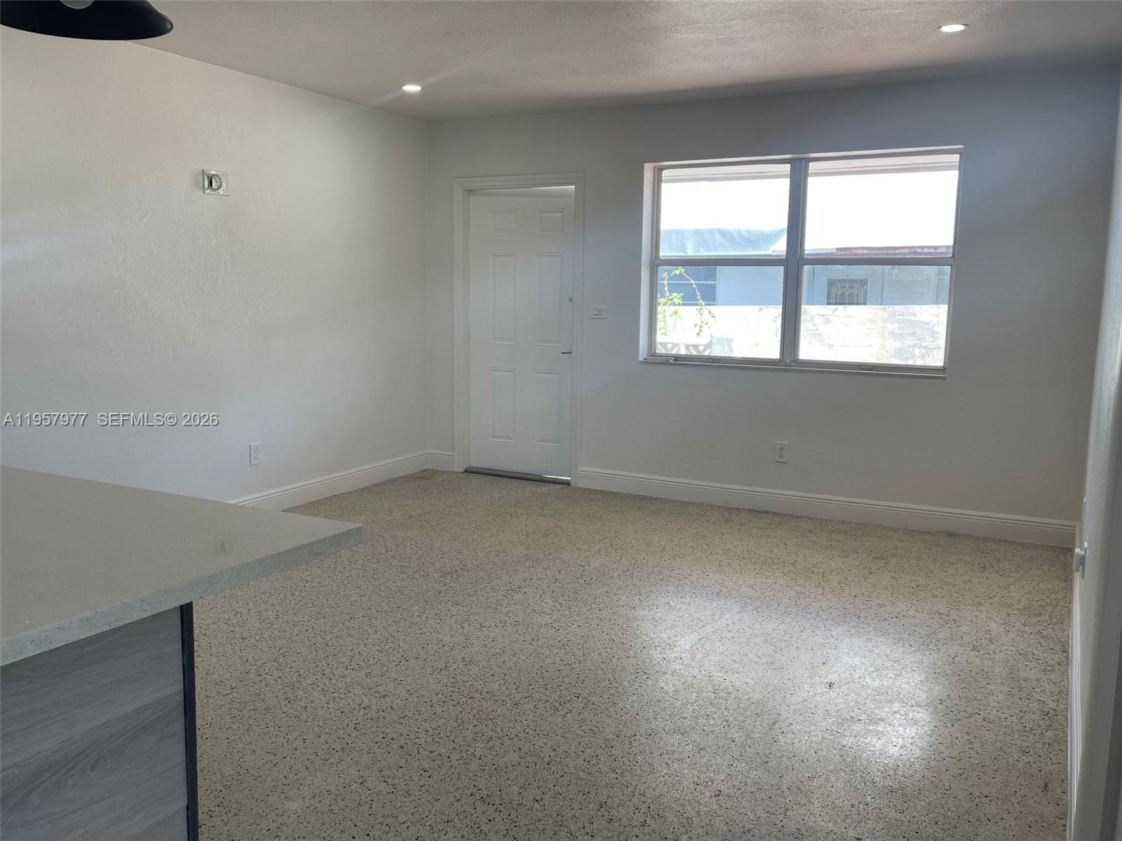 4727 Northwest 4th Street, Unit 4727 Miami, FL 33126 - Photo 2 of 14 an empty room with a window