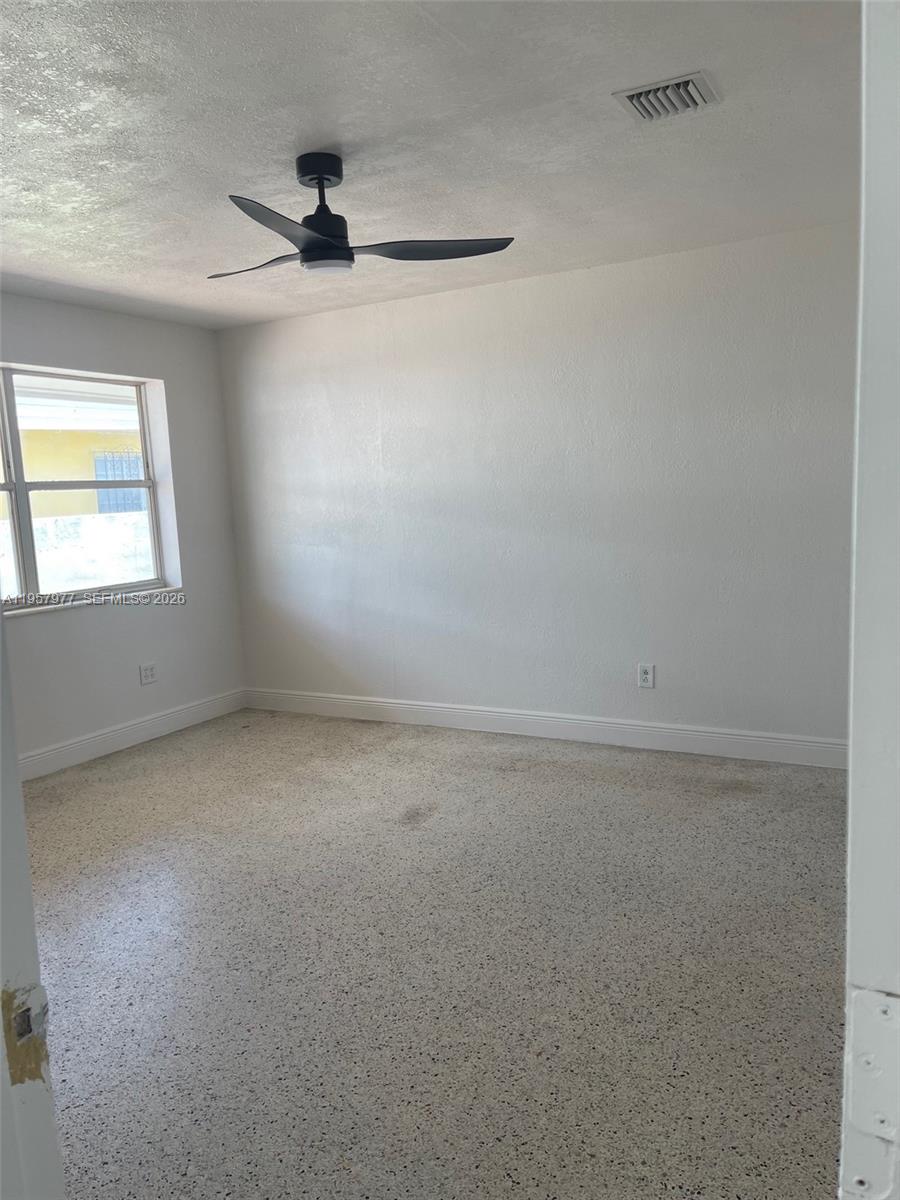 4727 Northwest 4th Street, Unit 4727 Miami, FL 33126 - Photo 5 of 14 an empty room with a window and a ceiling fan