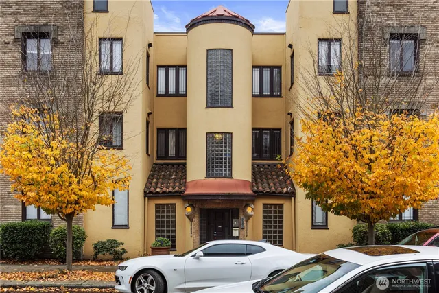 a front view of a building with a garden and plants
