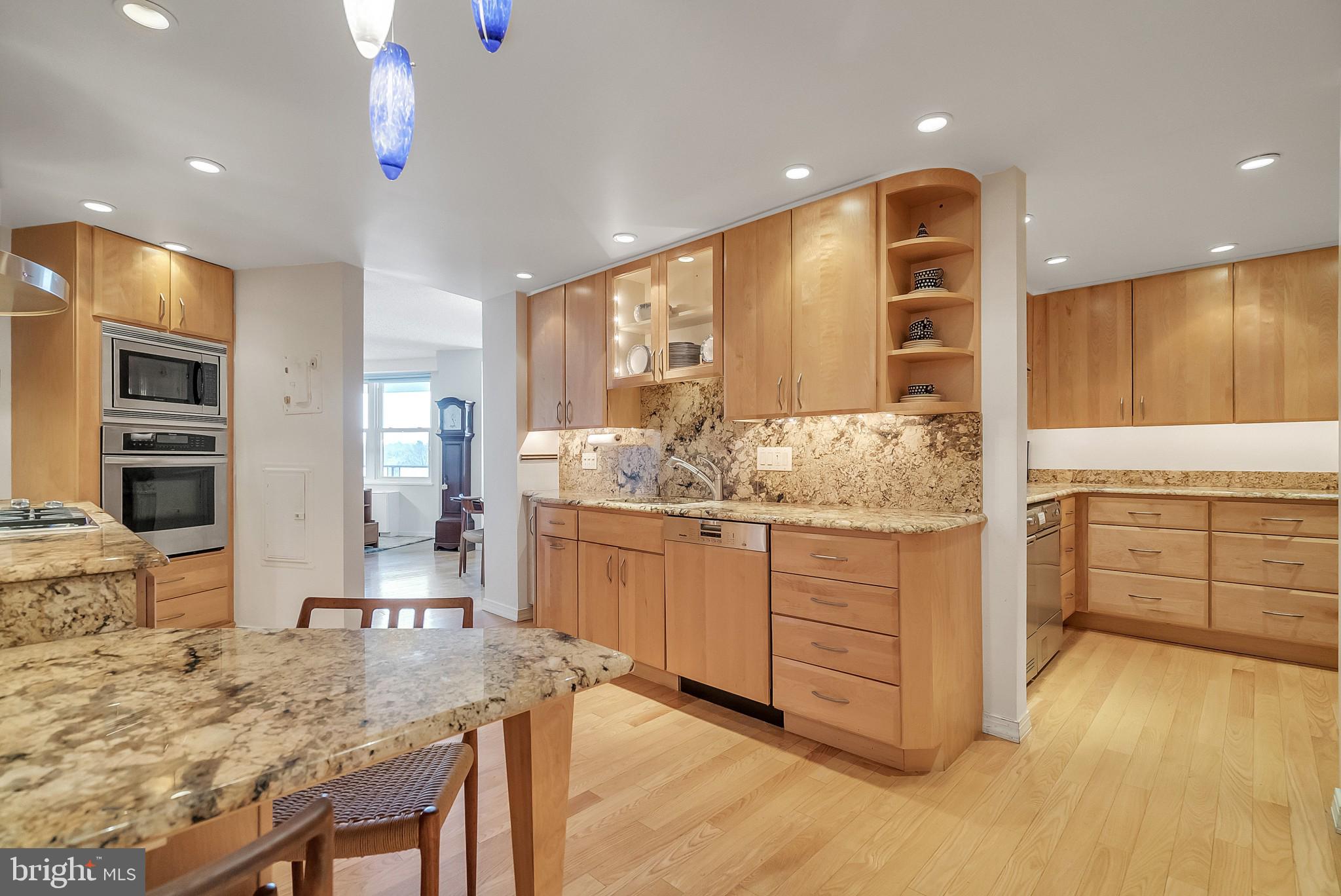 a kitchen with granite countertop cabinets and window