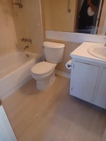 a bathroom with a toilet a sink and bathtub