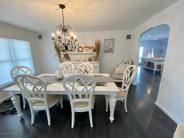 a view of a dining room with furniture wooden floor and chandelier