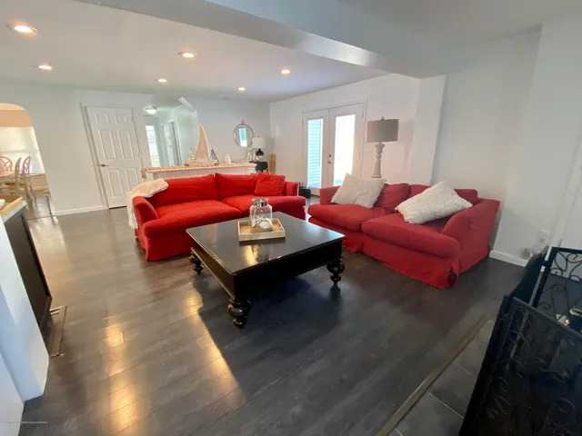 a living room with furniture a rug and a potted plant