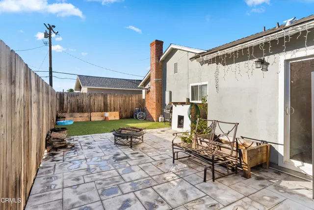 a view of a patio with table and chairs with wooden fence