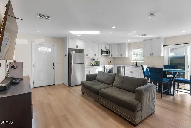 a living room kitchen with furniture and a view of kitchen