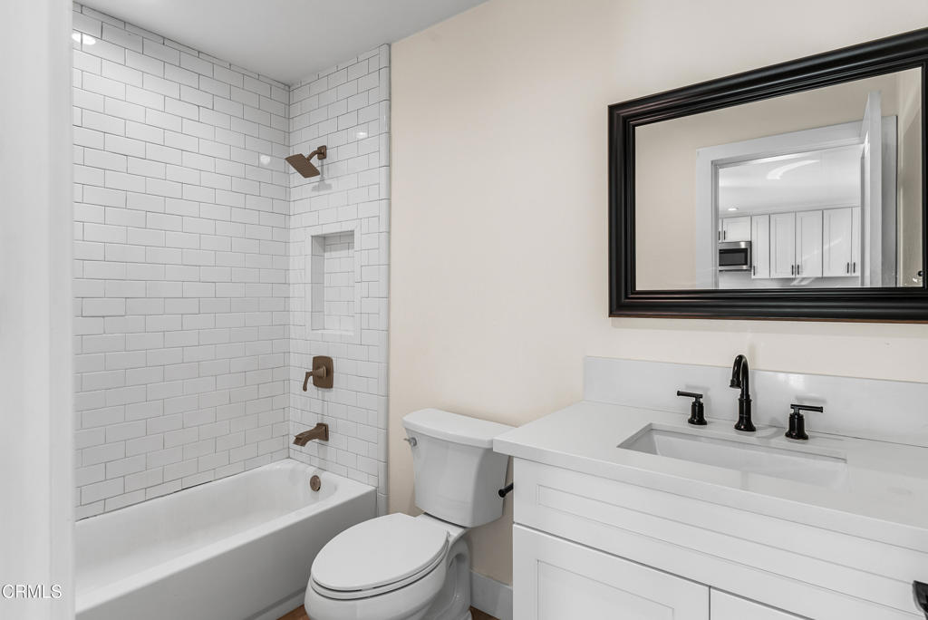 2549 Young Avenue, Unit B Thousand Oaks, CA 91360 - Photo 8 of 14 a bathroom with a toilet sink a mirror a bathtub and shower