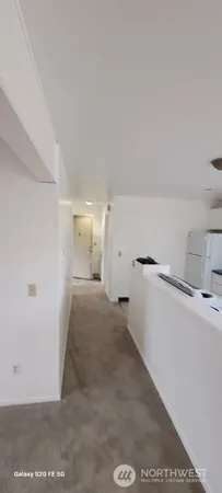 a kitchen with kitchen island a sink a stove and a refrigerator