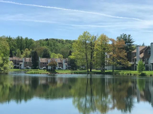 a view of residential house with outdoor space and lake