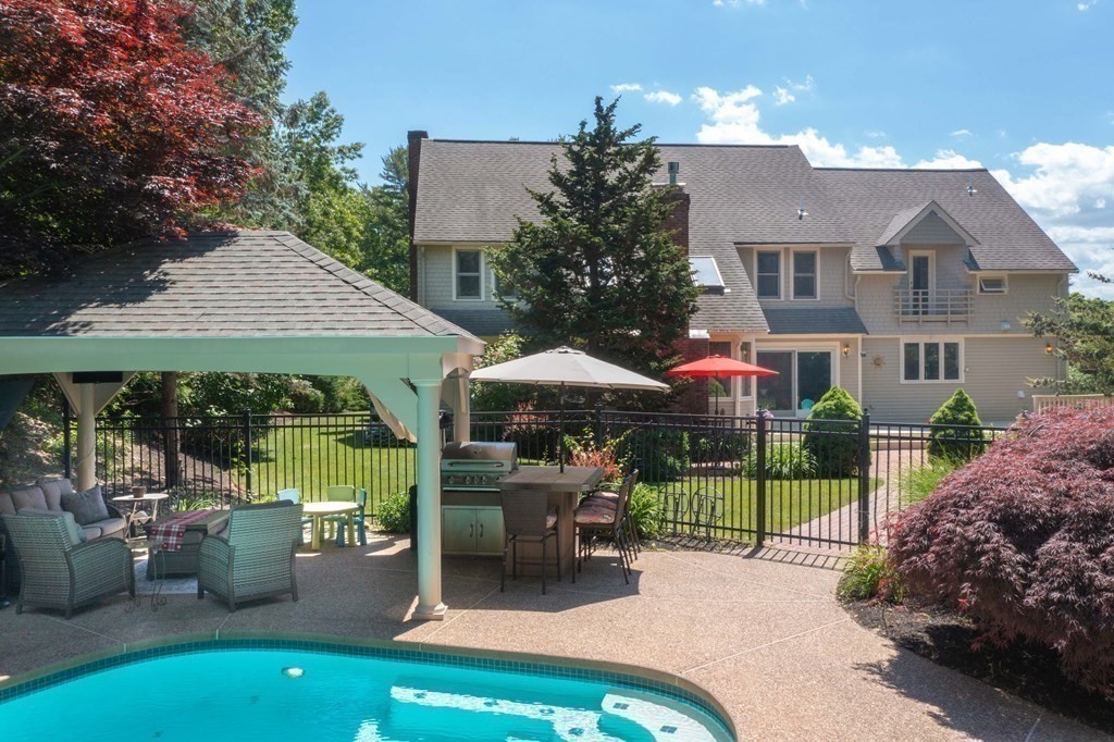 10 Windsor Lane Marshfield, MA 02050 - Photo 25 of 31 a patio with a table and chairs under an umbrella