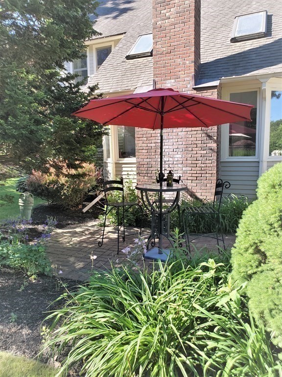 10 Windsor Lane Marshfield, MA 02050 - Photo 27 of 31 an outdoor view of patio with umbrella and chairs