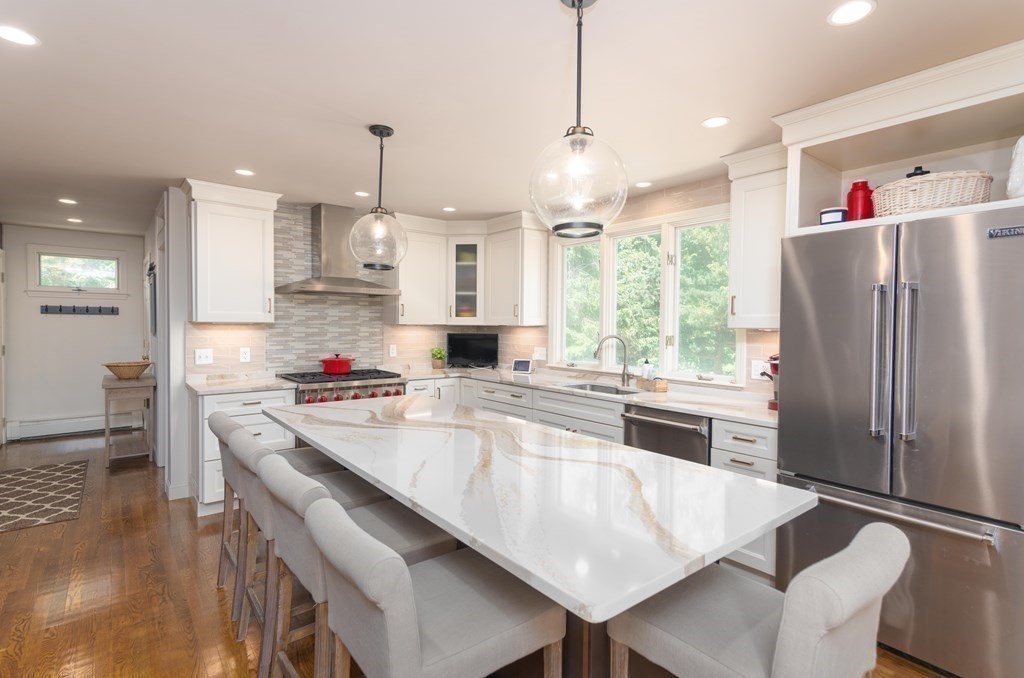 10 Windsor Lane Marshfield, MA 02050 - Photo 7 of 31 a kitchen with stainless steel appliances granite countertop a refrigerator a sink dishwasher a stove and white countertops with wooden floor