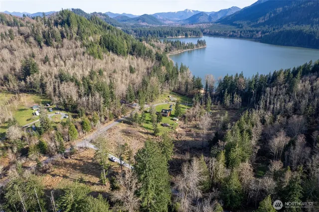 a view of a house with a lake and a mountain view