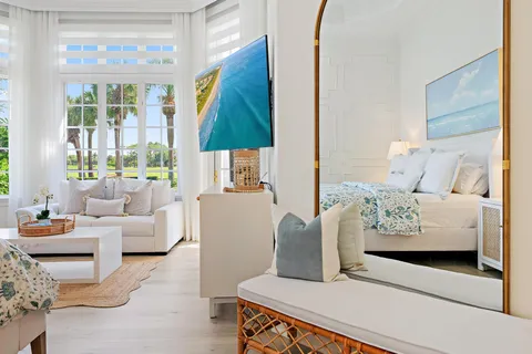 a bedroom with a bed and a large window with outer view
