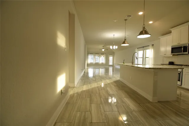 a view of a kitchen with a sink and wooden floor