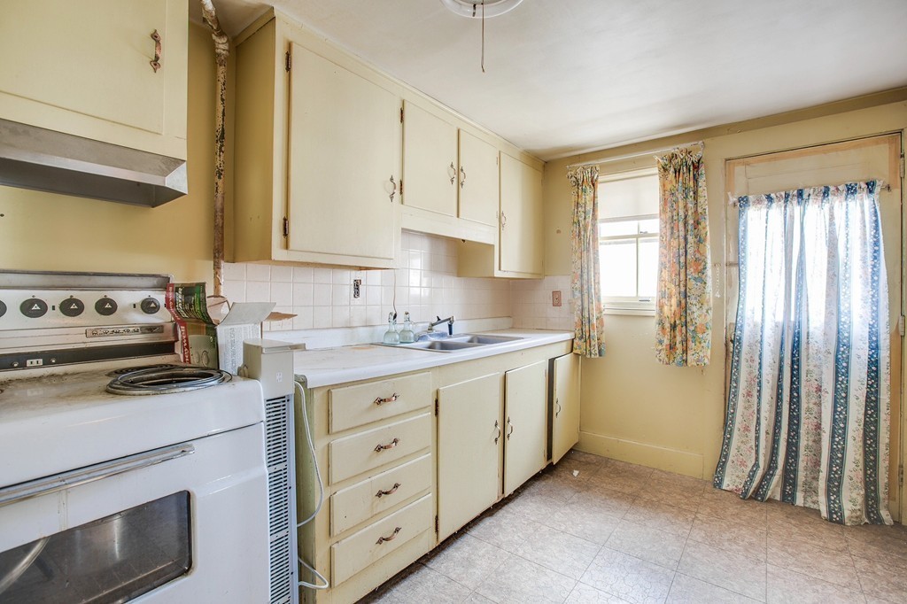 218 West Street Reading, MA 01867 - Photo 12 of 22 a kitchen with cabinets stainless steel appliances and window