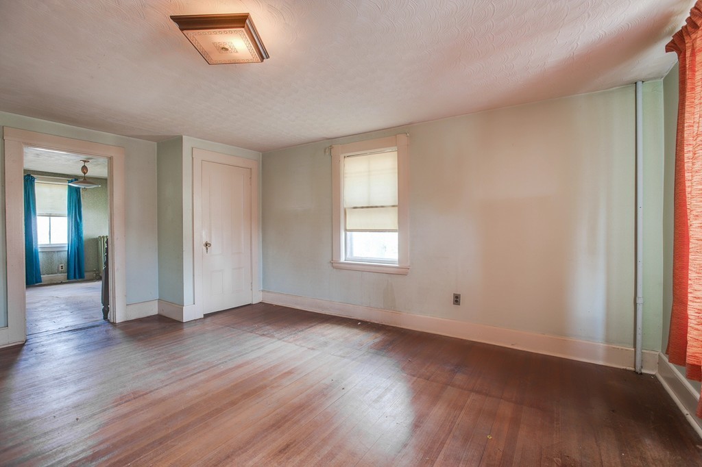 218 West Street Reading, MA 01867 - Photo 15 of 22 an empty room with wooden floor and windows