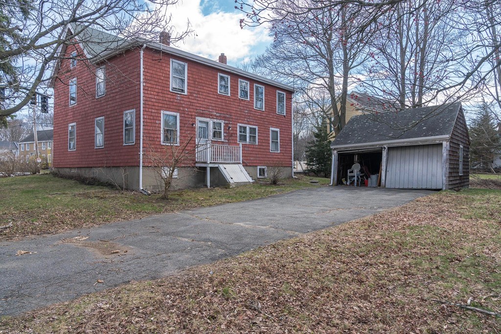 218 West Street Reading, MA 01867 - Photo 2 of 22 a front view of a house with a yard and garage