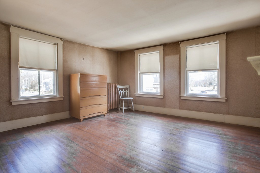 218 West Street Reading, MA 01867 - Photo 21 of 22 a view of an empty room with wooden floor and a window