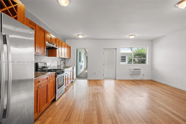 a view of a kitchen with a sink stove and refrigerator