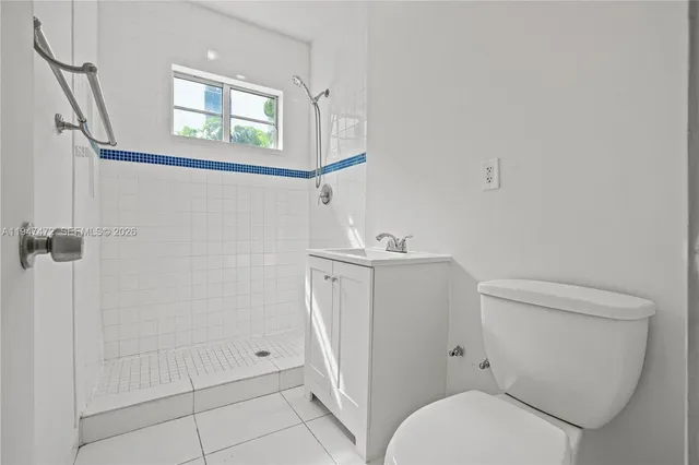 a white toilet sitting next to a bathroom sink