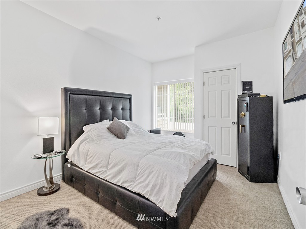 801 Rainier Avenue North, Unit G234 Renton, WA 98057 - Photo 12 of 19 a bedroom with a bed and a closet